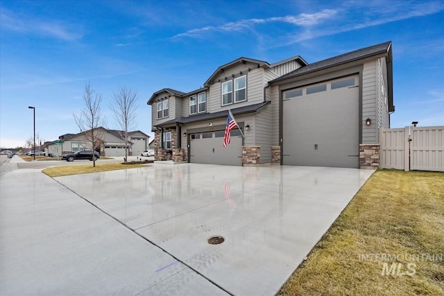 view of front facade featuring stone siding, fence, and concrete driveway