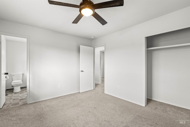 unfurnished bedroom with ensuite bath, light carpet, a closet, and ceiling fan