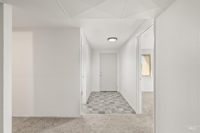 hallway with light colored carpet