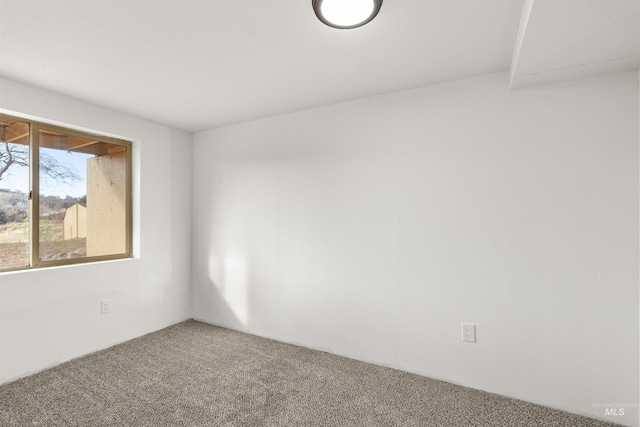 unfurnished room featuring carpet