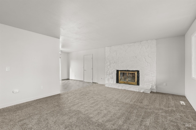 unfurnished living room featuring carpet and a fireplace