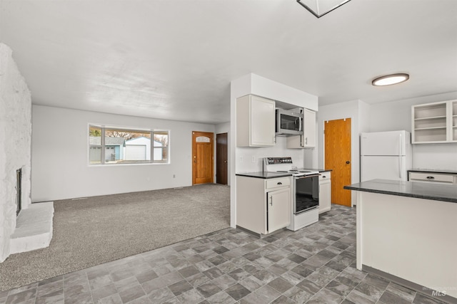 kitchen with white cabinets, white appliances, and dark colored carpet