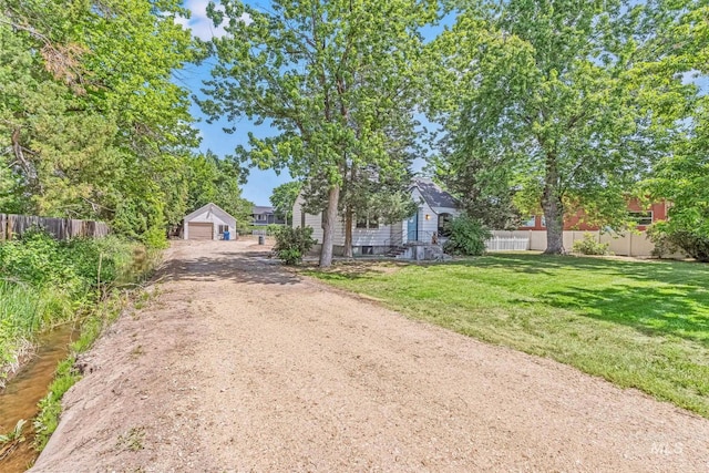404 N Allumbaugh St, Boise, ID 83704 - obstructed view of property featuring a detached garage, driveway, and an outbuilding