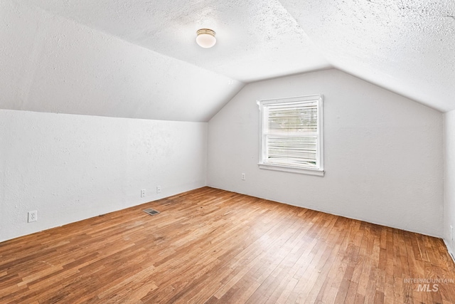 404 N Allumbaugh St, Boise, ID 83704 - bonus room with hardwood / wood-style flooring, a textured ceiling, and lofted ceiling