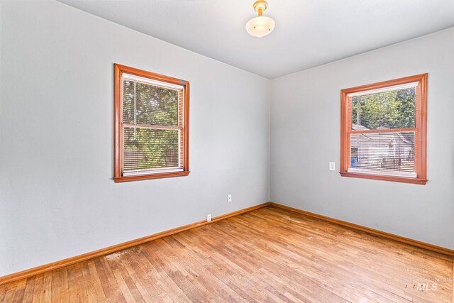 404 N Allumbaugh St, Boise, ID 83704 - unfurnished room featuring plenty of natural light, baseboards, and light wood finished floors