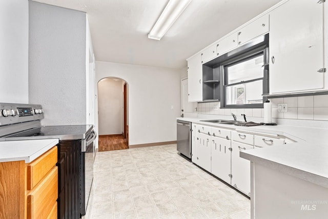 404 N Allumbaugh St, Boise, ID 83704 - kitchen with appliances with stainless steel finishes, a sink, arched walkways, light floors, and light countertops