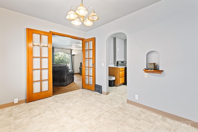 404 N Allumbaugh St, Boise, ID 83704 - empty room featuring french doors, a chandelier, arched walkways, and baseboards