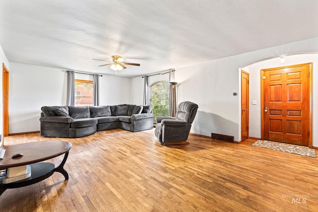 404 N Allumbaugh St, Boise, ID 83704 - living area with hardwood / wood-style flooring, ceiling fan, arched walkways, and healthy amount of natural light
