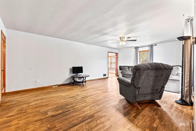 404 N Allumbaugh St, Boise, ID 83704 - living area featuring wood finished floors, a ceiling fan, and baseboards
