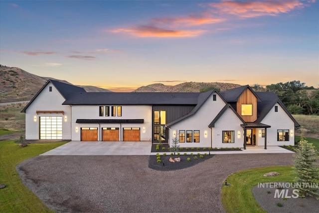 6162 N High Valley Way, Boise, ID 83714 - view of front of house featuring driveway, an attached garage, board and batten siding, and a mountain view