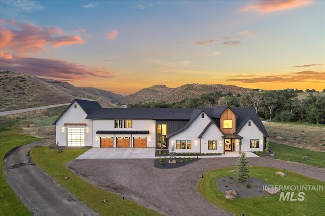 6162 N High Valley Way, Boise, ID 83714 - view of front of house with curved driveway, a garage, a mountain view, and stucco siding