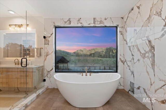 6162 N High Valley Way, Boise, ID 83714 - bathroom featuring a freestanding tub, vanity, and tile walls