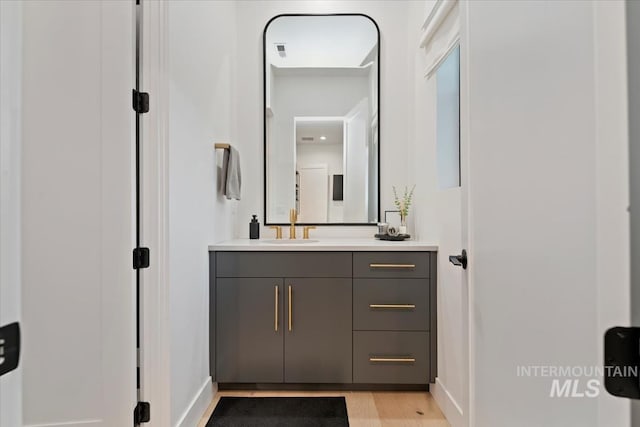 6162 N High Valley Way, Boise, ID 83714 - bathroom with vanity, wood finished floors, and baseboards