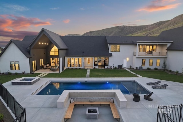 6162 N High Valley Way, Boise, ID 83714 - rear view of house with an in-ground hot tub, an outdoor fire pit, a mountain view, and an outdoor pool