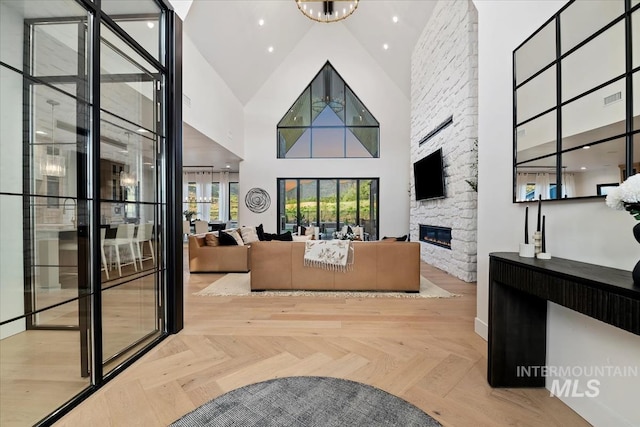 6162 N High Valley Way, Boise, ID 83714 - reception area featuring high vaulted ceiling, a fireplace, and a chandelier