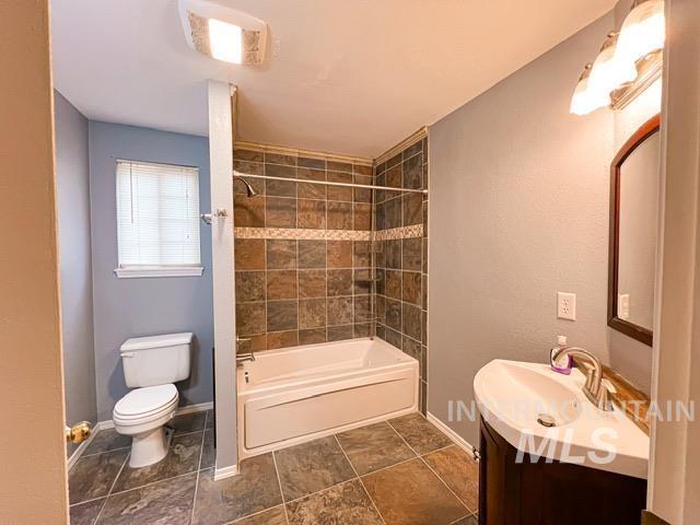 kitchen with white cabinetry, stainless steel appliances, light tile patterned flooring, and sink