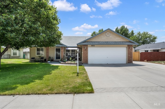 single story home with a garage and a front lawn