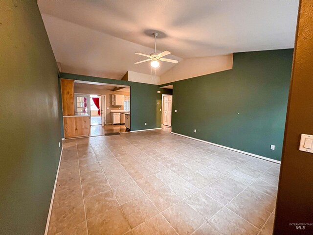 living room with light hardwood / wood-style floors, a wood stove, lofted ceiling, and ceiling fan