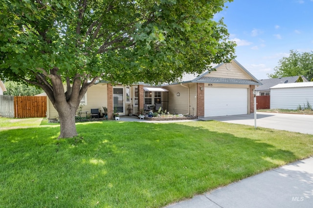 obstructed view of property featuring a garage and a front yard