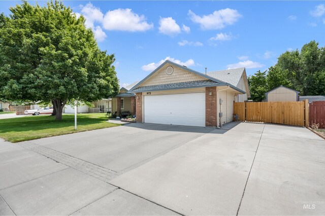 ranch-style home with a garage and a front lawn