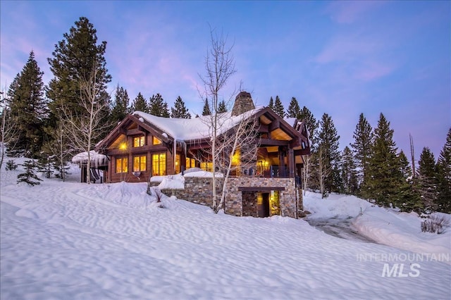 view of snow covered rear of property