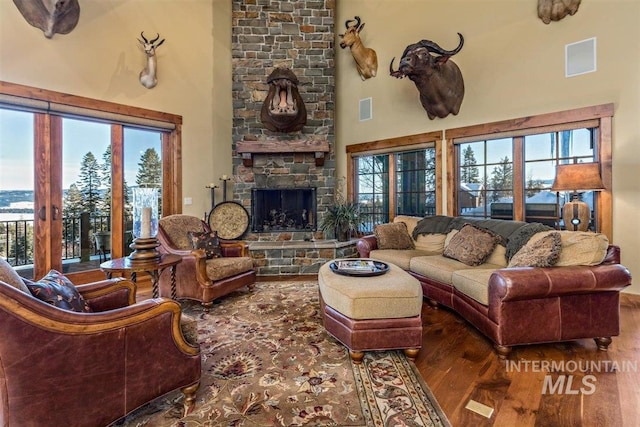 516 Whitewater Dr, Donnelly, ID 83615 - living room featuring a healthy amount of sunlight, a fireplace, and dark hardwood / wood-style flooring