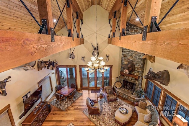 516 Whitewater Dr, Donnelly, ID 83615 - unfurnished living room featuring a notable chandelier, hardwood / wood-style flooring, high vaulted ceiling, and wood ceiling