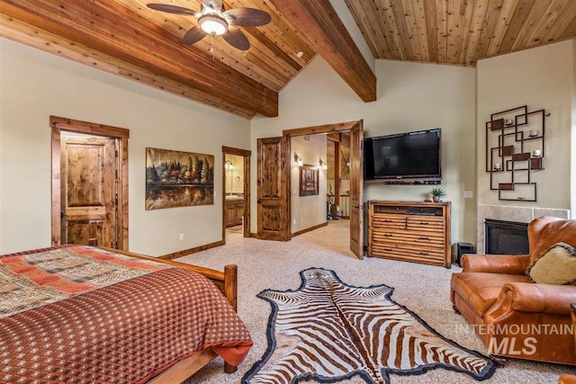 516 Whitewater Dr, Donnelly, ID 83615 - carpeted bedroom with ceiling fan, a tile fireplace, beamed ceiling, wooden ceiling, and ensuite bath