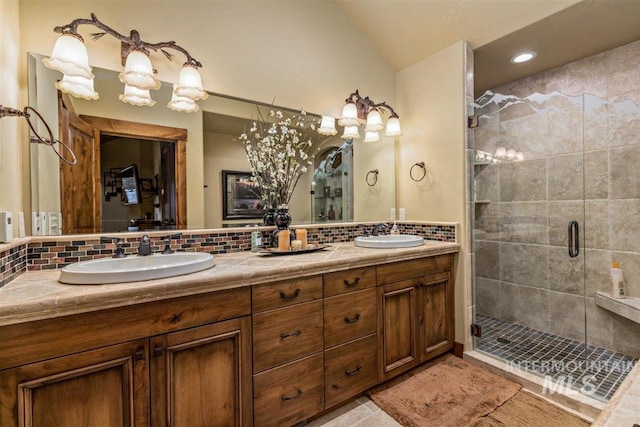 516 Whitewater Dr, Donnelly, ID 83615 - bathroom with double sink, vanity with extensive cabinet space, a shower with door, tile flooring, and tasteful backsplash