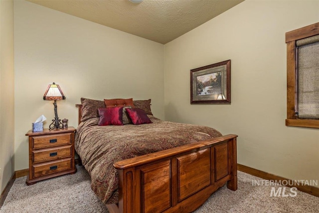 516 Whitewater Dr, Donnelly, ID 83615 - carpeted bedroom with vaulted ceiling and a textured ceiling