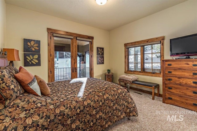 516 Whitewater Dr, Donnelly, ID 83615 - bedroom with access to exterior and light colored carpet