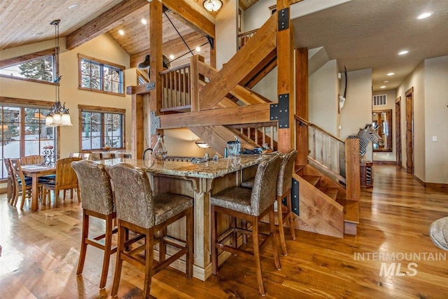 516 Whitewater Dr, Donnelly, ID 83615 - kitchen featuring a notable chandelier, hardwood / wood-style floors, decorative light fixtures, and high vaulted ceiling