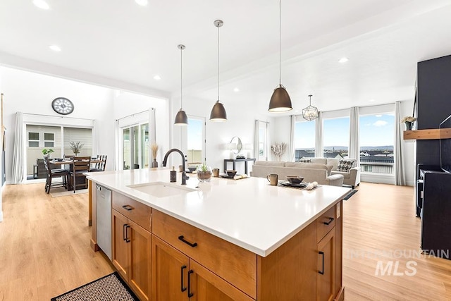 3012 E Parulo Dr, Meridian, ID 83642 - kitchen with brown cabinets, stainless steel dishwasher, a sink, and light countertops