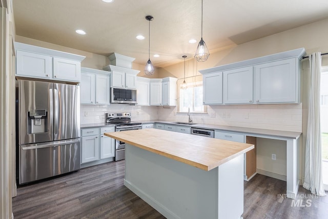 11965 Goldfinch St, Caldwell, ID 83605 - kitchen featuring stainless steel appliances, a sink, butcher block countertops, dark wood-style flooring, and decorative backsplash
