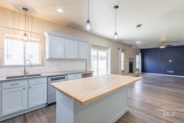11965 Goldfinch St, Caldwell, ID 83605 - kitchen with stainless steel dishwasher, a sink, wooden counters, open floor plan, and ceiling fan