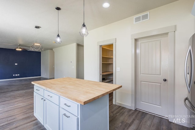 11965 Goldfinch St, Caldwell, ID 83605 - kitchen featuring dark wood finished floors, wooden counters, white cabinetry, baseboards, and recessed lighting
