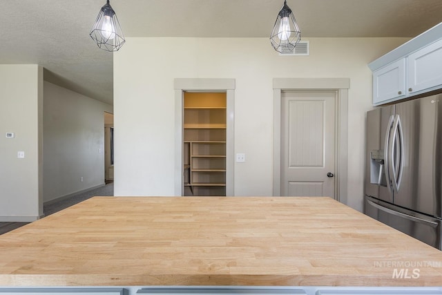 11965 Goldfinch St, Caldwell, ID 83605 - kitchen featuring stainless steel fridge with ice dispenser, light countertops, a kitchen island, and decorative light fixtures