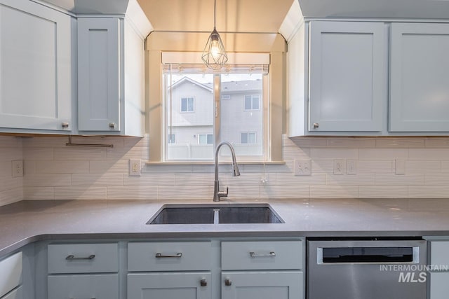 11965 Goldfinch St, Caldwell, ID 83605 - kitchen with dishwasher, a sink, tasteful backsplash, decorative light fixtures, and dark countertops