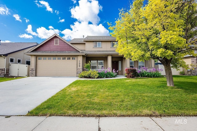 11965 Goldfinch St, Caldwell, ID 83605 - view of front of house with an attached garage, covered porch, concrete driveway, and stone siding