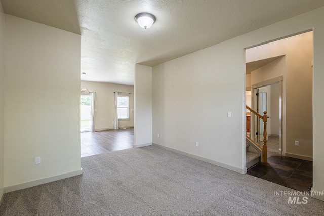 11965 Goldfinch St, Caldwell, ID 83605 - spare room with carpet flooring, stairs, baseboards, and a textured ceiling