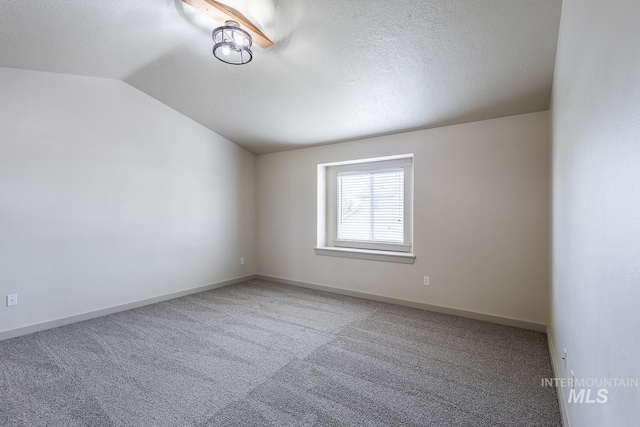 11965 Goldfinch St, Caldwell, ID 83605 - carpeted empty room featuring lofted ceiling, baseboards, and a textured ceiling