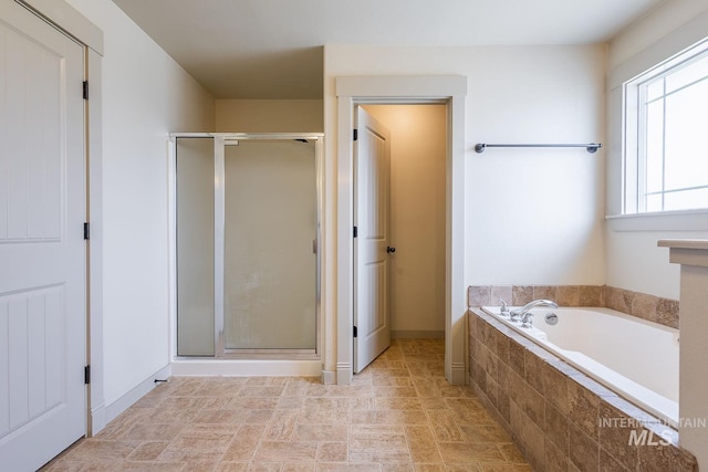 11965 Goldfinch St, Caldwell, ID 83605 - bathroom featuring a shower stall, a bath, stone finish floors, and baseboards