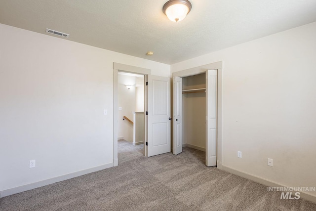 11965 Goldfinch St, Caldwell, ID 83605 - unfurnished bedroom with light colored carpet, baseboards, and a closet