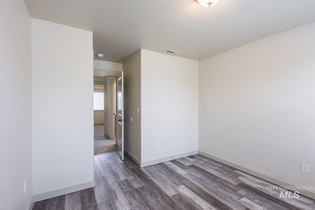 11965 Goldfinch St, Caldwell, ID 83605 - unfurnished room with wood finished floors, baseboards, and a textured ceiling