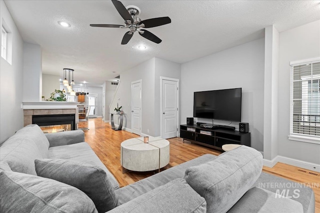 2315 N 22nd St, Boise, ID 83702 - living area with light wood-style floors, baseboards, a textured ceiling, and visible vents