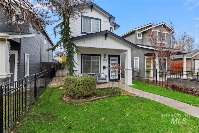 2315 N 22nd St, Boise, ID 83702 - view of front of property with fence private yard, board and batten siding, covered porch, and a front yard
