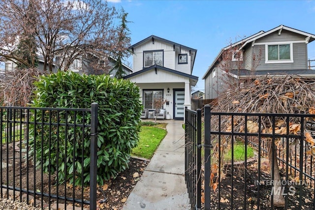 2315 N 22nd St, Boise, ID 83702 - view of front of property with a gate, a fenced front yard, board and batten siding, and covered porch