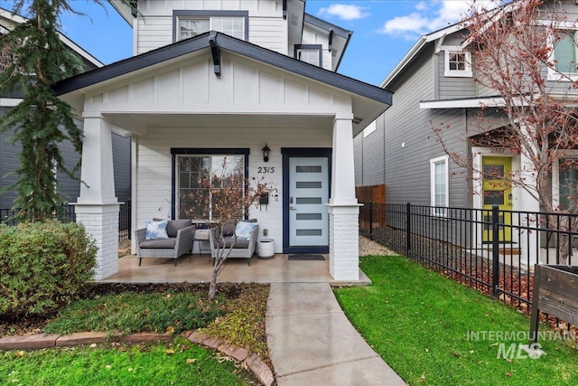 2315 N 22nd St, Boise, ID 83702 - view of front of home featuring board and batten siding, fence, and a porch