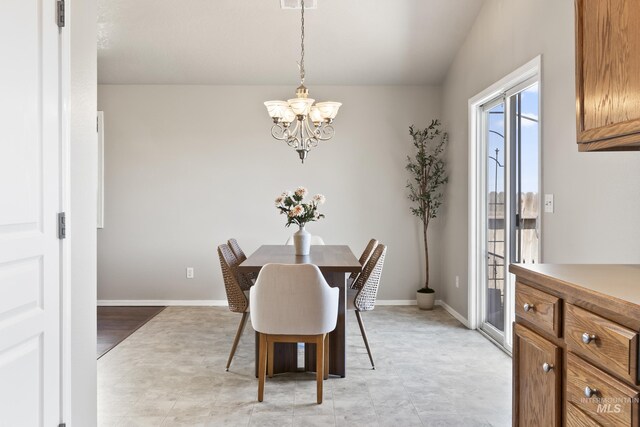 dining room featuring baseboards and a notable chandelier