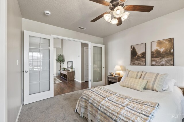 carpeted bedroom featuring ceiling fan, baseboards, visible vents, and french doors